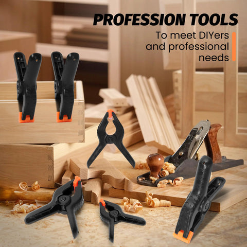 10-pack 4.5-inch black plastic spring clamps with orange non-slip pads on a woodworking bench.