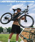 Man lifting Gnarly Urban Electric Mountain Bike For Adults And Teens with 28 MPH Peak, showcasing lightweight design.