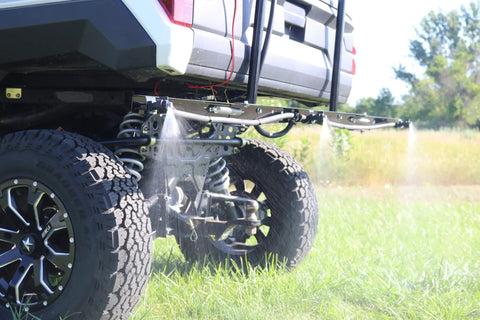 40 Gallon UTV Broadcast Sprayer With 2.2 GPM Diaphragm Pump and 10 Foot Swath spray system in action on a grassy field