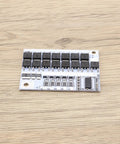 Straight Up Killer 2 Pack 5S Battery Management System 100A BMS Circuit Board with relays and connectors on wooden background.