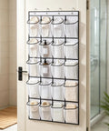 Over The Door Shoe Rack With 28 Spacious Pockets For Max Storage Capacity Breathable Mesh Hanging Shoe Organizer mounted on a door.