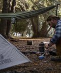 Man setting up camp with tent and Camping Hammock With 400 Lb Capacity And Heavy Duty Straps And Carabiners Navigator Series Pink