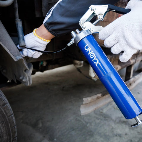 Mechanic using Heavy Duty Pistol Grip Grease Gun Kit 14oz Mini Grease Gun With 6000 PSI Leakproof Seal on automotive part