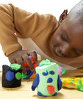 Child crafting with colorful modeling clay from the Game Changing Modeling Compound Haul With 65 Mini Cans.