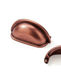 Close-up of 10 Pack 3 Inch Vintage Cup Pulls Antique Copper Cabinet Hardware with a focus on antique copper finish and shape.