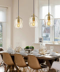 Pendant Lights Kitchen Island, Hand-Blown Clear Glass Brass Gold 9 Inch H hanging above a dining table with white dishware.