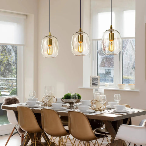 Pendant Lights Kitchen Island, Hand-Blown Clear Glass Brass Gold 9 Inch H hanging above a dining table with white dishware.