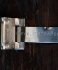 Stainless Steel Bull's Eye Sign Mounting Brackets With Straight Leg on wooden post, showing engraved website detail.