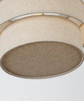 Close-up of beige three-tier linen drum shade for E26 ceiling pendant light, visible fabric texture and round shape.