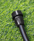 Close-up of Three Pack One Half Inch Drip Irrigation Tubing To Three Quarters Inch Garden Hose Adapter Fittings on grass