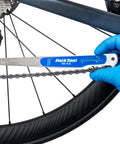 Using No Guesswork Bicycle Chain Wear Checker Pro Grade Gauge on bike chain for quick maintenance check.