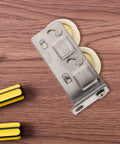 Heavy Duty Stainless Steel Sliding Door Window Pulley Roller Replacement Runs Smooth As Butter Track Wheel Guide for Interior Cabinets on wooden surface.