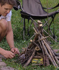 Person using Fast Ignite Fire Starters 24 Pack For Indoor Outdoor Fires, No Mess Quick Ignition Logs for campfire setup