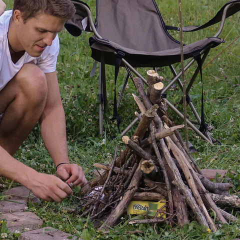 Person using Fast Ignite Fire Starters 24 Pack For Indoor Outdoor Fires, No Mess Quick Ignition Logs for campfire setup