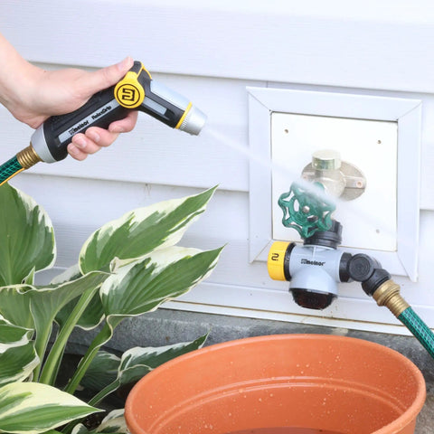 Relaxgrip Gardening Nozzle And Wash And Fill Set With No Squeeze Thumb Control spraying water on patio plants