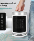 Smart 1500W Space Heater With WiFi Thermostat Remote And 12 Hour Timer Delivers Fast Even Indoor Heat For Living Rooms And Offices With Ceramic PTC Heating For Cozy Comfort All Winter being held by hand