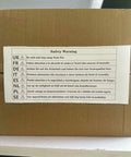Safety warning label on a cardboard box featuring multi-language fire safety instructions for Big Batch Commercial Grade Electric Digital Food Dehydrator With Heavy Duty Trays For Fresh Fruits Veggies And Homemade Pet Jerky 1000 Watt 110 Volt Powerhouse Machine.