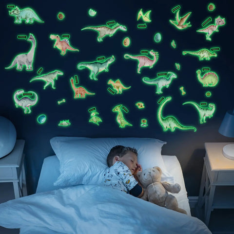 Child sleeping under glow in the dark dinosaur decals on wall