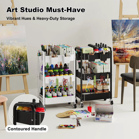 Art studio with a Three Tier Metal Rolling Cart On Wheels In Black filled with art supplies, next to a white trolley and easels.