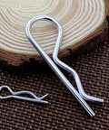 Close-up of heavy duty stainless steel roll pin and cotter pin from 30 piece assortment for trailer hitches mowers trucks towing accessories.