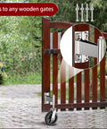 Eight Inch Heavy Duty Fence Gate Wheel With Spring Loaded Shock Absorber For Metal Tube Gates mounted under a wooden gate.