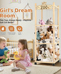56 Inch Tall Wooden Stuffed Animal Storage Tower With Wheels in playroom, filled with plush toys, with children playing nearby.