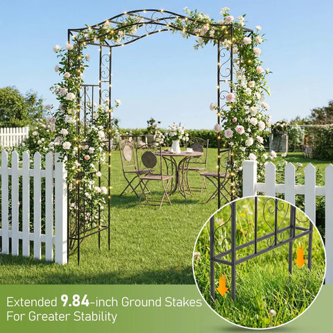 Metal Garden Arch Trellis For Climbing Plants, Durable Iron Garden Arbor With Long Ground Stakes in a blooming yard.