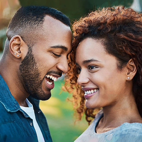 Couple smiling close together, both wearing Fresh Hypoallergenic Titanium Stud Earrings With Secure Screwback Cap For Sensitive Ears Silver Tone.