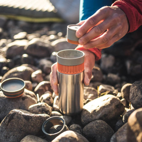 All In One Portable Coffee Maker With Vacuum Pressure Brew Hand Powered On The Go Coffee Brewer Insulated Stainless Steel Travel Mug 10 Ounce Thermo Cup Quick Fresh Brew For Commutes And Outdoors being assembled outdoors on rocks