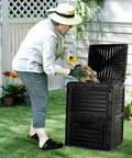 Person using 80 Gallon Outdoor Compost Bin With Top Flip Lid BPA Free Large Garden Composter For Kitchen And Yard Scraps Easy Assembly Sturdy Black Barrel Turns Waste Into Nutrient Rich Soil In Weeks