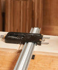 Top Shelf Router Dado Jig With CNC Machined Aluminum Carriage And One Inch Precision Bushing for precise cutting of wood slots.