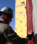 Construction worker applying FastFlash Fluid Applied Flashing Membrane for Windows Waterproof And Airtight Pro Grade Sealant.
