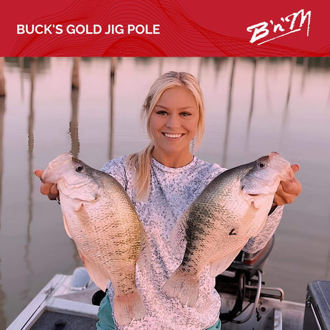 Angler holding two large fish caught with Buck's Gold Jig Pole in boat at sunset, showcasing successful fishing trip.