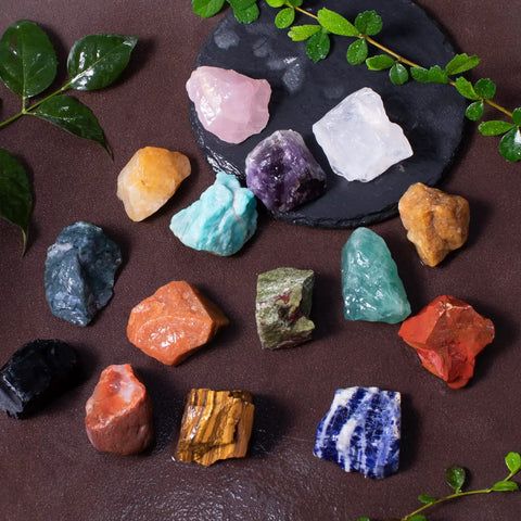 3 Pound Bulk Rough Madagascar Stones Mix including various natural raw crystals for tumbling and cabbing on a black surface