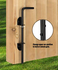 12 Inch Cane Bolt Heavy Duty Drop Rod Gate Stopper Hardware installed on a wooden gate, black powder-coated finish, close-up view