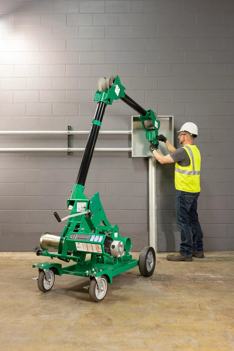 Greenlee 10k Tugger Package Featuring Dual Speed Motor For Faster Pulls, Real-Time Force Indicator Display And Heavy Duty Mobile VersiBoom Tow Rig Gear in use at job site.
