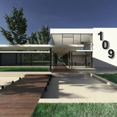 Modern home exterior with large black address numbers on white wall, featuring floating design and minimal architecture.