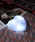 Two Pack Heart Shape Purse Lights With Sensor Illuminator For Handbags Battery Powered Night Light glowing on a surface