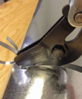 Pipe and Duct Cutter for One and a Quarter Inch Cuts with Cold Rolled Steel Construction cutting a metal duct, close-up view
