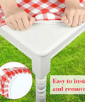 Close-up of Three Piece Fitted Picnic Table Cover Set With Bench Covers Vinyl Tablecloth With Flannel Backing For 6ft Tables Outdoor Camping Red Checked 30 By 72 Inches Water And Oil Resistant Elastic Edges For A Snug Stayput Fit being installed.