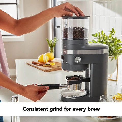 Premium Burr Coffee Grinder With Smart Dosing Technology For Dead Simple French Press To Espresso Ground Settings In Smooth Charcoal Grey Design, showcasing convenient use with freshly ground coffee.