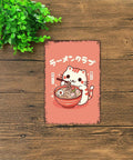 Retro Rugged Cat Eating Ramen Metal Sign 8x12inch Tin Poster on wooden surface with green plant