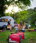 Smooth Operator 2200 Watt Portable Inverter Generator 120 Volt Output Featuring Smart Co Minder Safety Technology in red at a campsite.