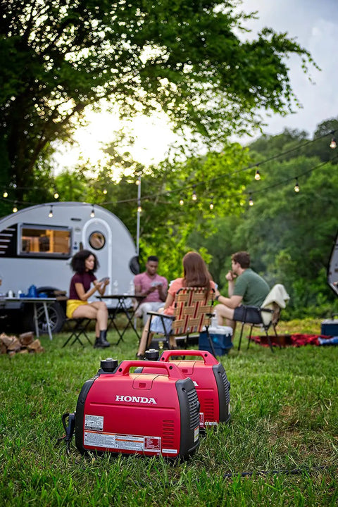 Smooth Operator 2200 Watt Portable Inverter Generator 120 Volt Output Featuring Smart Co Minder Safety Technology in red at a campsite.