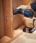 Compact 18V Cordless Drill Driver With Brushless Motor And Rugged Locking Chuck Supporting 5In1 Flexiclick Quick Swap System Paired With A Badass 4Ah Battery Pack drilling into wood with a screw.