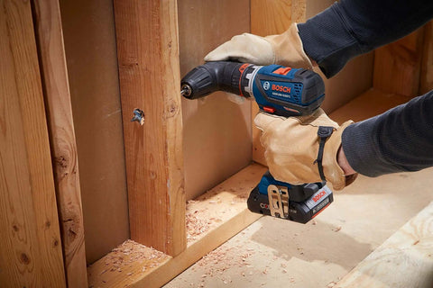 Compact 18V Cordless Drill Driver With Brushless Motor And Rugged Locking Chuck Supporting 5In1 Flexiclick Quick Swap System Paired With A Badass 4Ah Battery Pack drilling into wood with a screw.