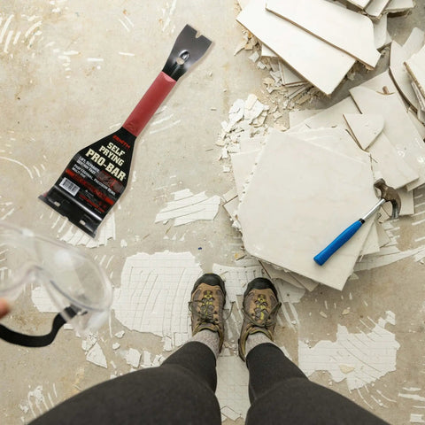 Self Prying Pro Bar Salvage Wrecking And Demolition Tool for Removing Large Floor Tiles shown with broken tiles on floor.