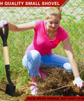 Woman using 28 Inch Mini Garden Shovel With D Grip Handle for gardening, featuring a wooden shaft and alloy steel head.