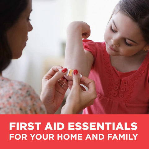 Adult applying a bandage on child's arm, showcasing first aid essentials for home and family