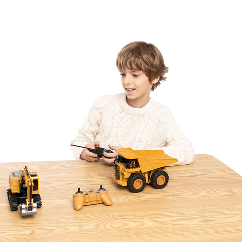 Child playing with Two Pack Remote Control Construction Vehicle Set With Friction Powered Excavator And Dump Truck Realistic Lights And Sounds